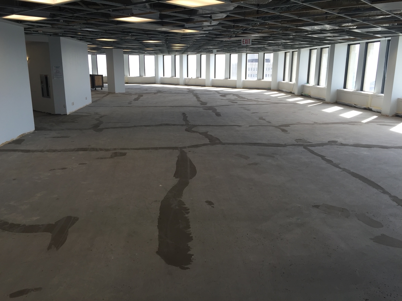 Downtown Office Calgary - BTF Concrete Services - Existing glue removal and patch, ready to receive new floor.